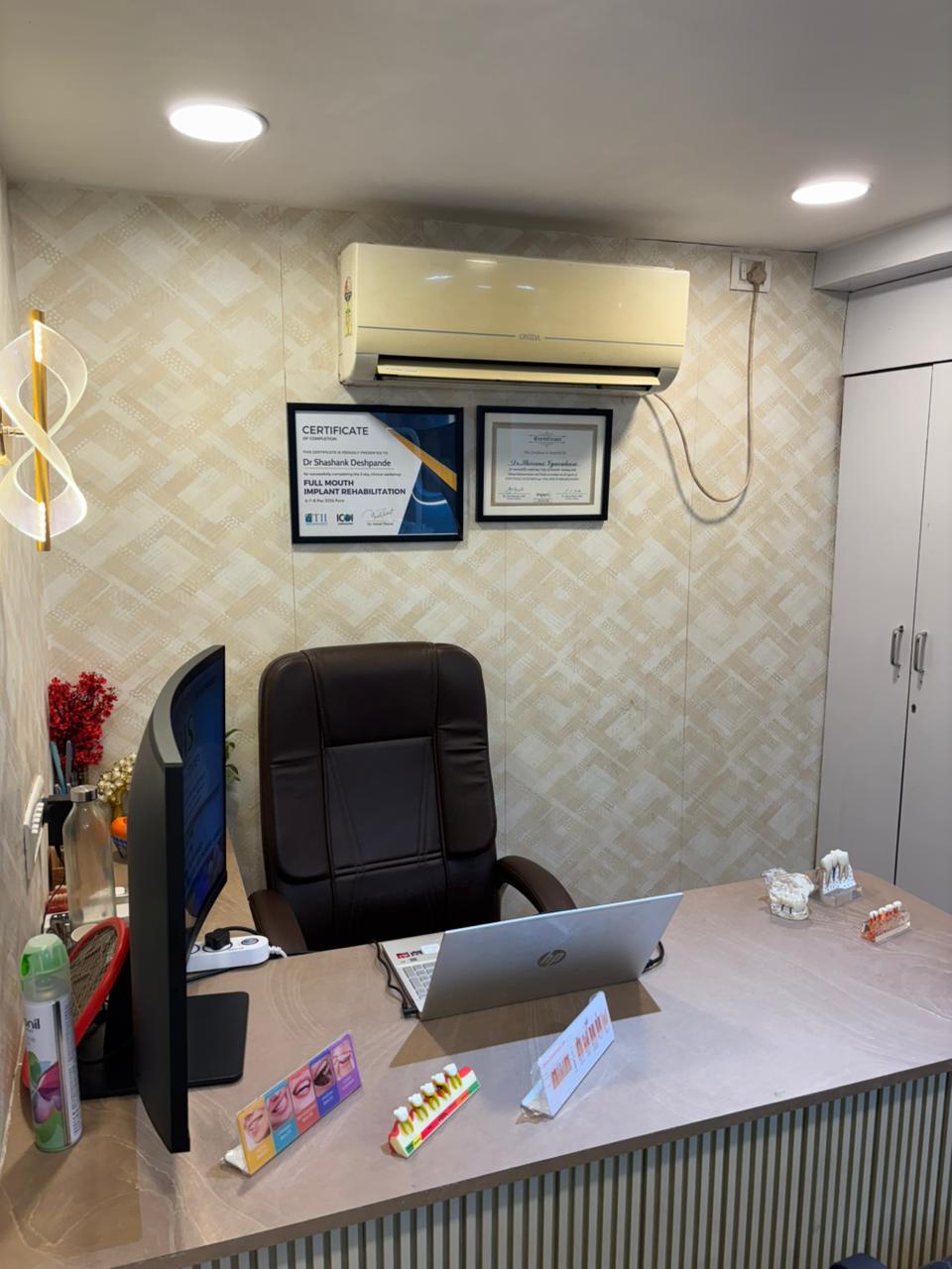 Consultation desk with monitor, implant models and treatment certificates