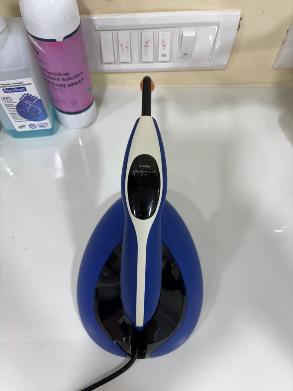 Ivoclar Bluephase N LED curing light on its charging stand