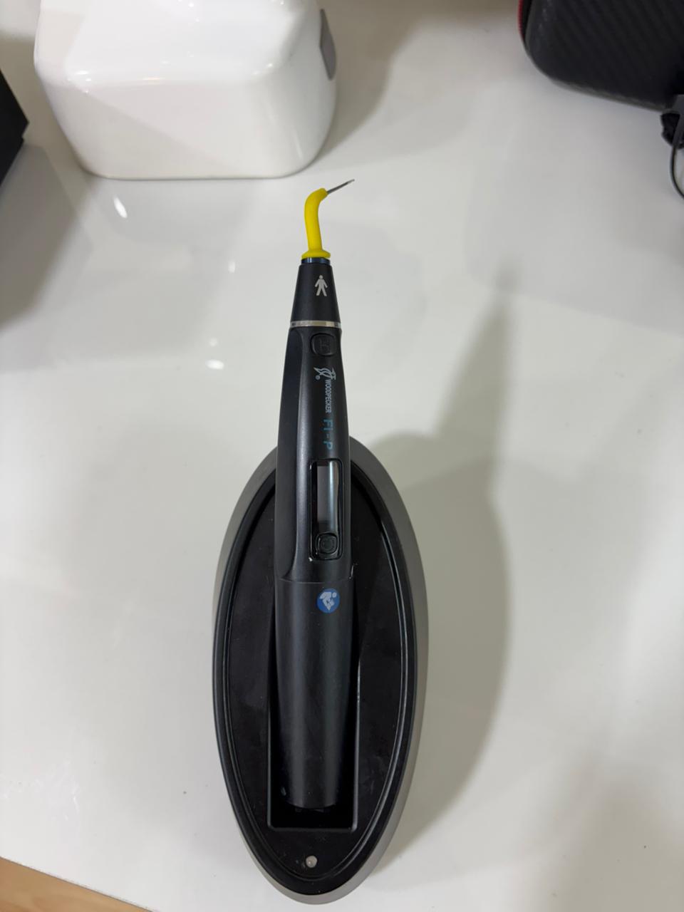 Woodpecker Fi-P cordless gutta-percha obturation pen on its base